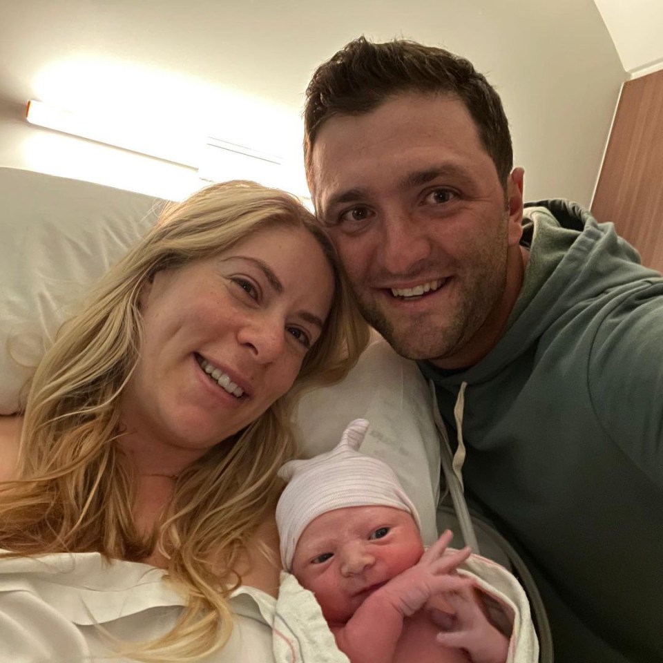 Jon Rahm poses with his wife and new baby