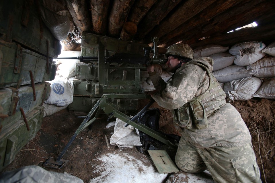 A Ukrainian serviceman holds a position at the front line