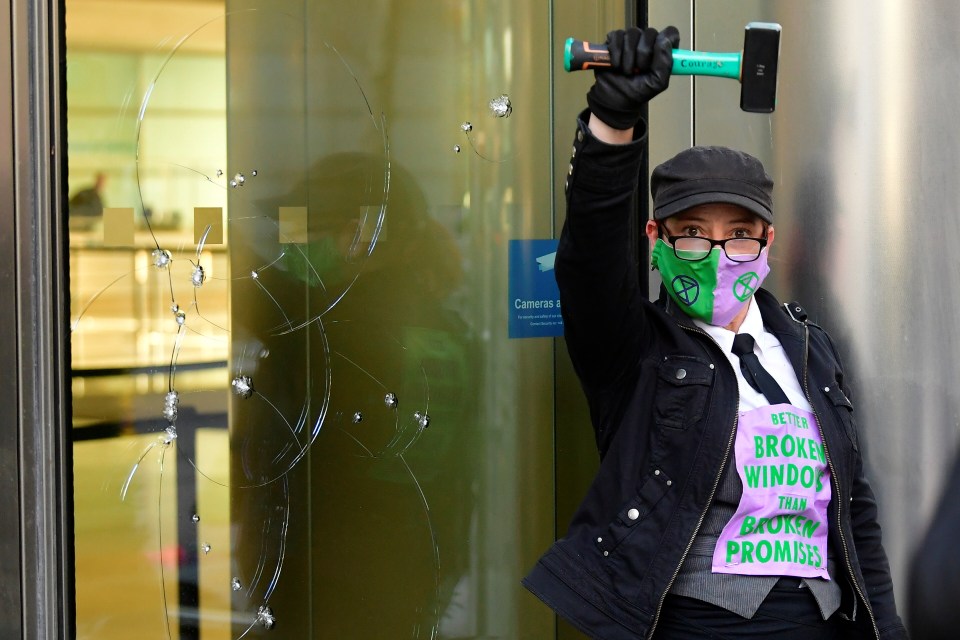 An activist from Extinction Rebellion takes part in a direct action at the Barclays HQ in Canary Wharf