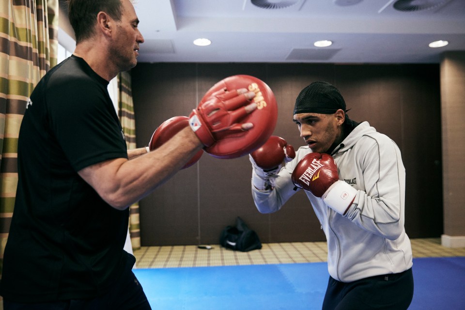 Trainer Tony Sims on the pads with Conor Benn