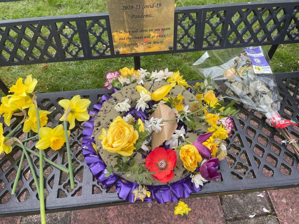 A wreath was torn a part with the flowers thrown onto the ground in front of the memorial