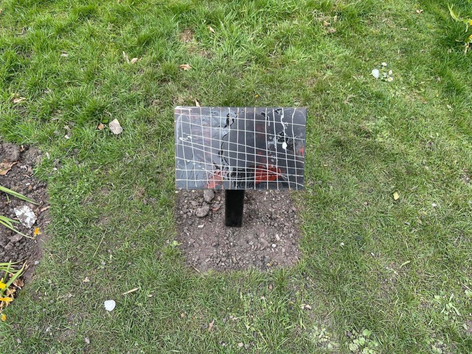 The memorial plaque beside the bench was destroyed