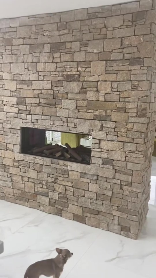 A fireplace separates the two spaces