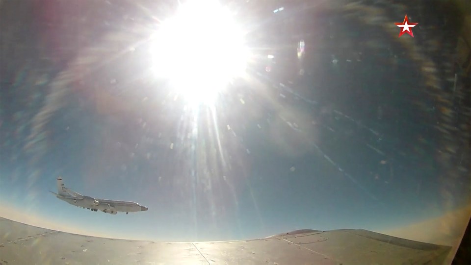 Footage appears to show a MiG-31 fighter jet intercepting a US RC-135 reconnaissance aircraft