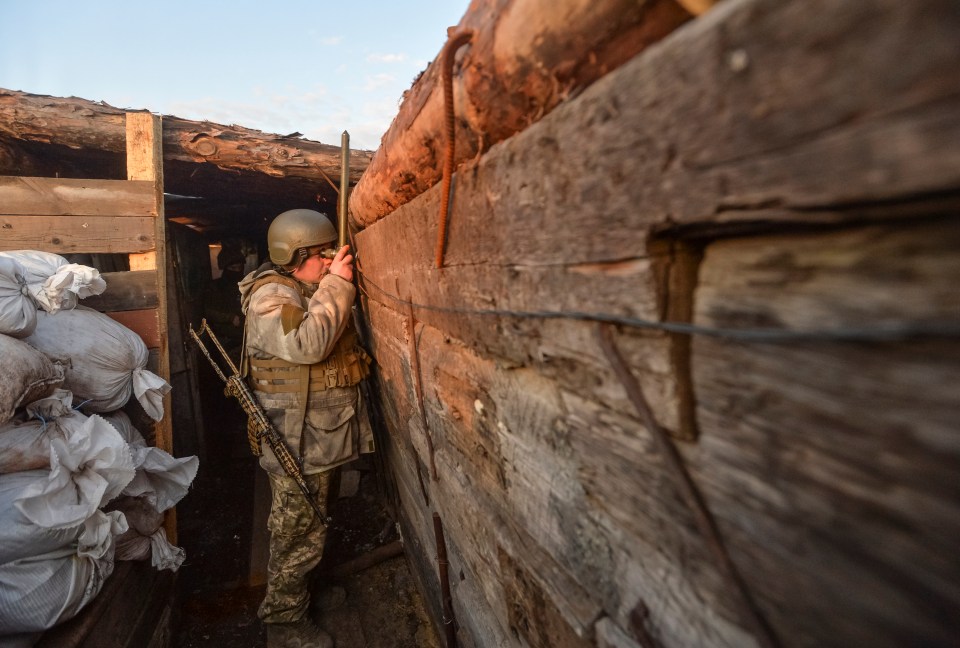 A service member of the Ukrainian armed forces is seen at fighting positions on the line of separation from pro-Russian rebels near Donetsk