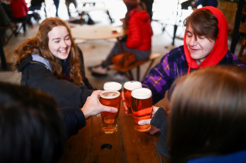 People enjoy their drinks at The Fox on the Hill pub after its reopening