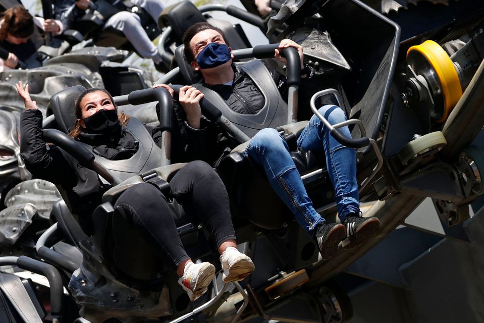 Members of the public enjoy the Swarm rollercoaster ride at Thorpe Park theme park in Chertsey, southwest London