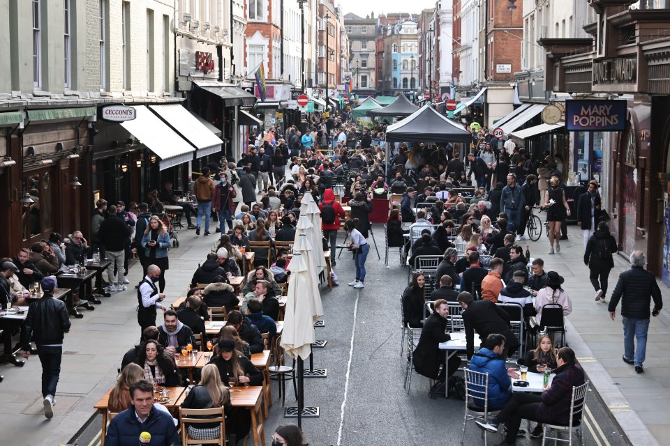 People enjoying drinks on Old Compton Street in Soho after lockdown restrictions were relaxed