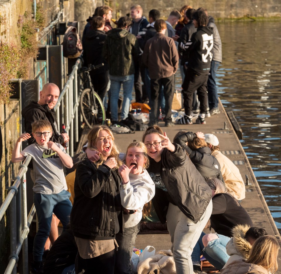 People on the quayside in the evening sunshine at Bristol Harbourside