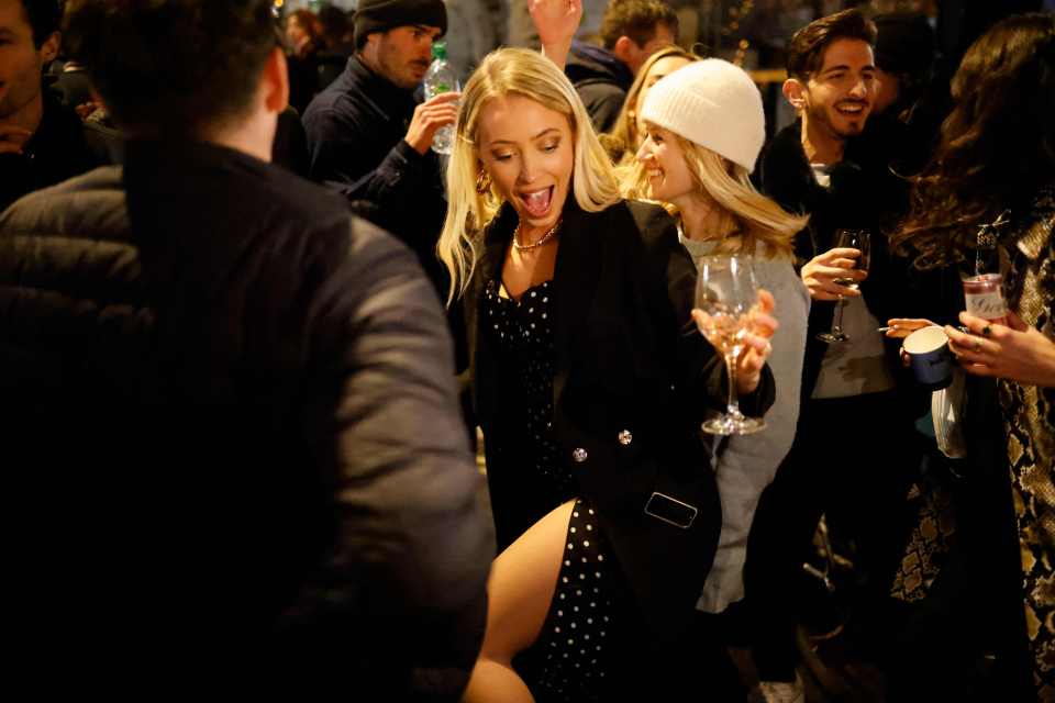 People dance in the street in the Soho area of London