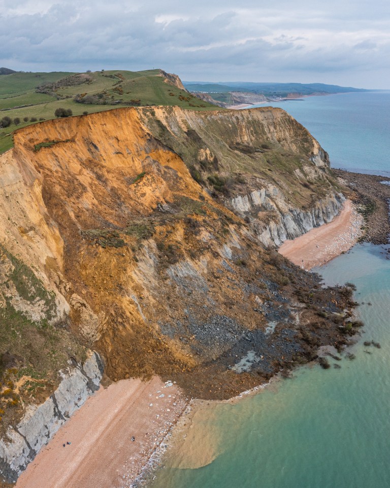 A whole segment of beach vanished beneath the rock that fell away from the cliff