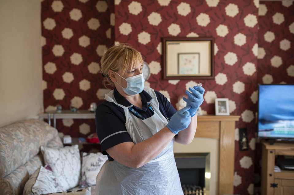 Julie Fletcher prepares to administer a dose of the AstraZeneca/Oxford Covid-19 vaccine