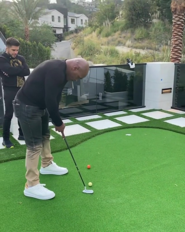 Iron Mike had a go on Arnie's putting green at his LA mansion