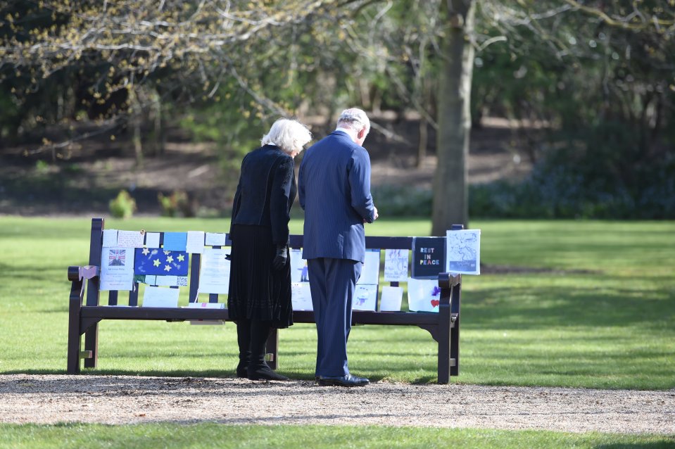 Charles and Camilla were pictured looking at tributes