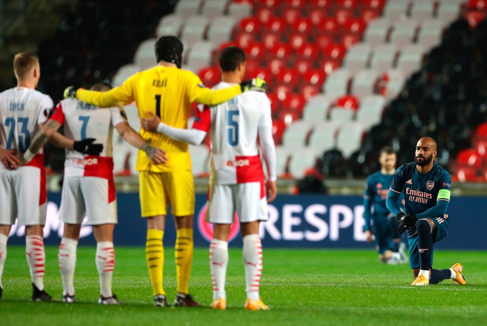 Lacazette knelt right in front of the standing Slavia Prague players in a defiant anti-racism message