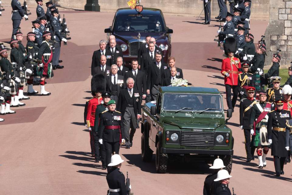 Members of the Royal family walk behind a land rover carrying the coffin