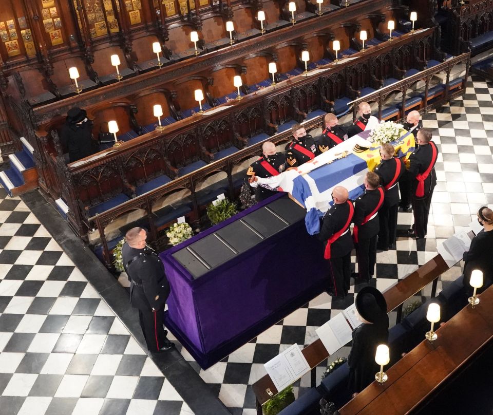 Queen Elizabeth II watches as pallbearers carry the coffin of the Duke of Edinburgh