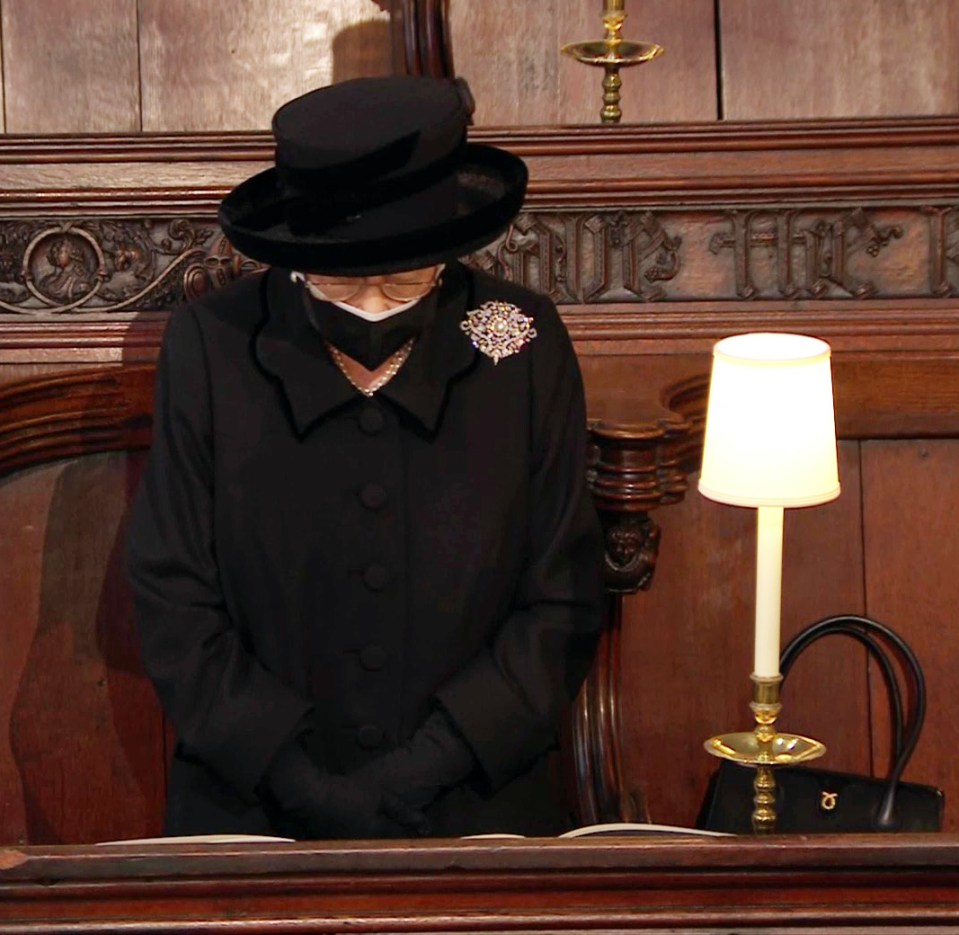 The Queen standing with her head bowed at the start of the service