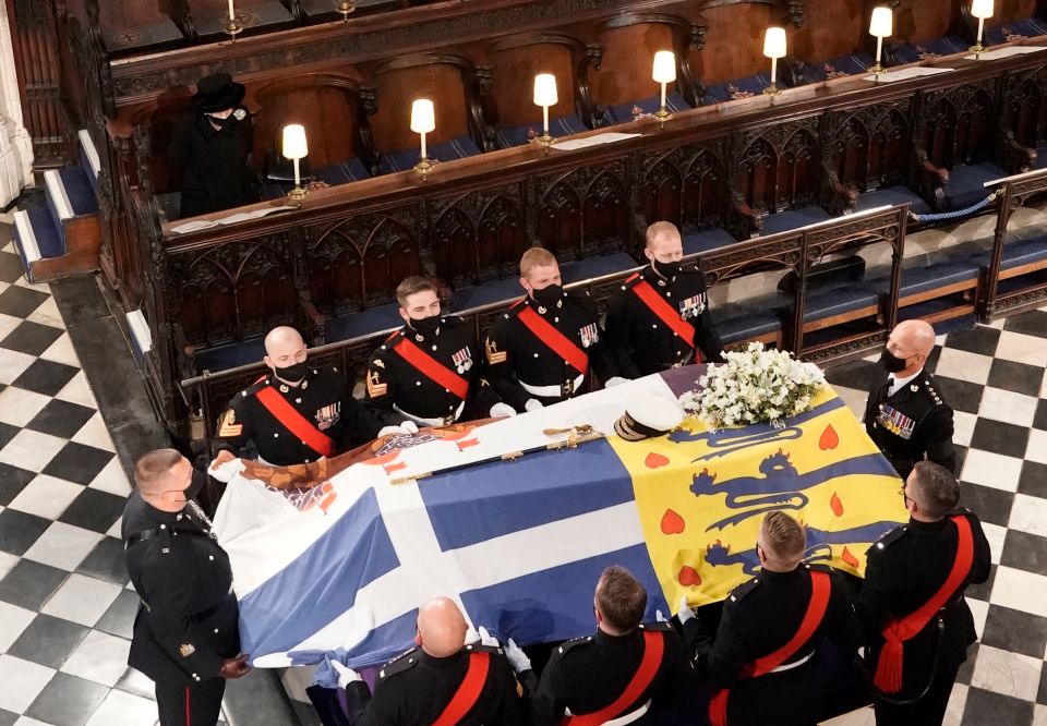 The Queen sitting by herself, as pallbearers carry the coffin of the Duke of Edinburgh during his funeral at St George's Chapel, Windsor Castle, Berkshire