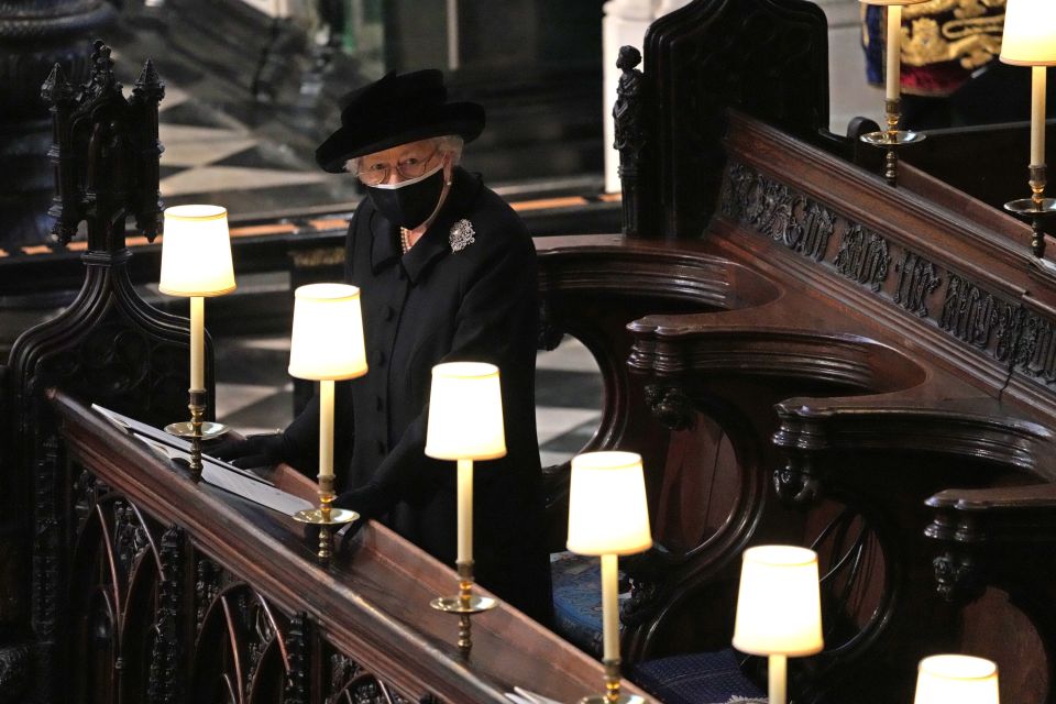 The Queen sat alone in St George's Chapel as her husband was laid to rest