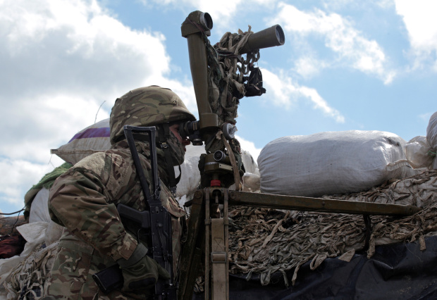 A Ukrainian soldier keeps on eye on rebel positions on the front line in Donetsk