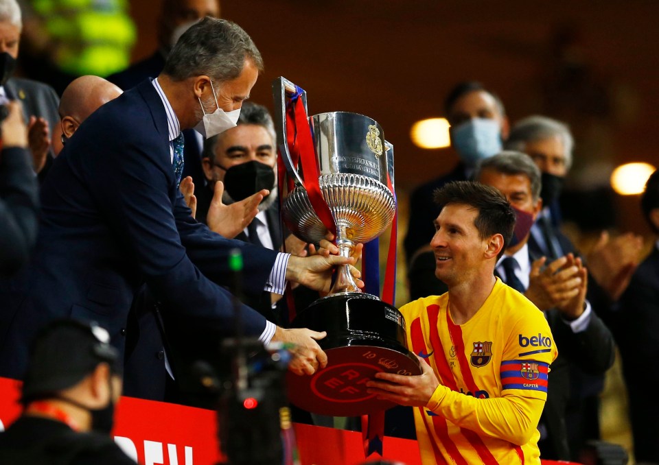 Lionel Messi collects the Copa Del Rey trophy for Barcelona