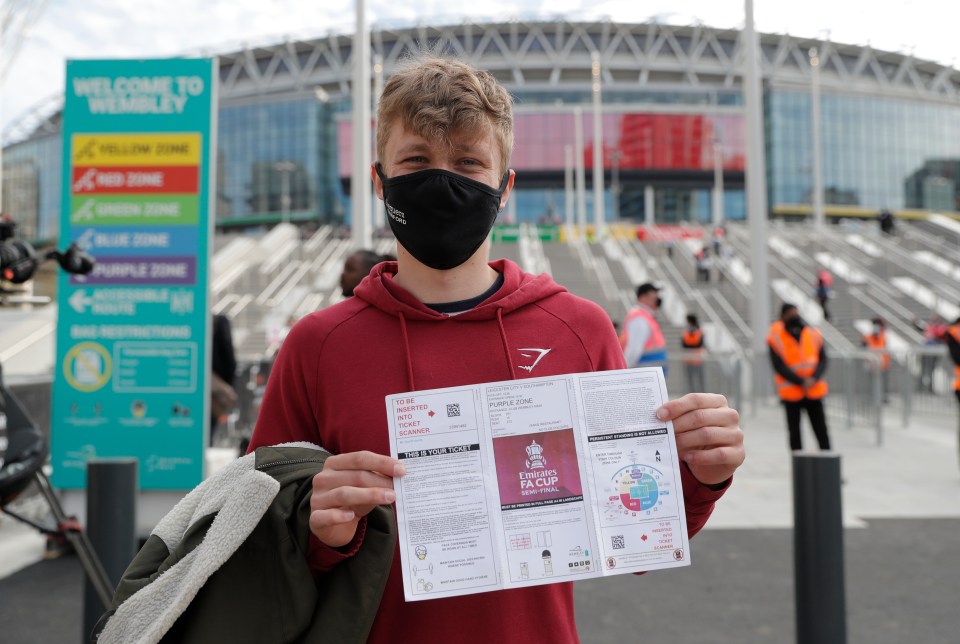 Looking chuffed, this young fan shows off his entry proof for the huge occasion