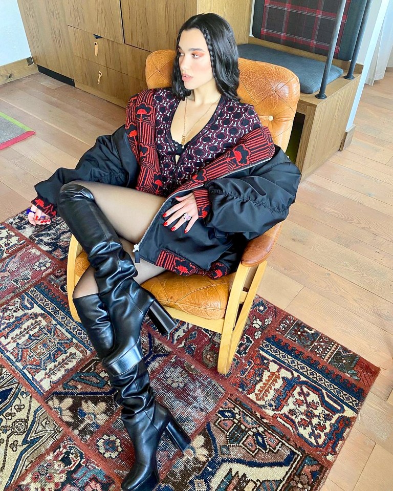 Dua Lipa enjoyed a well-earned sit down while wearing an oversized jacket and boots in this Instagram photo