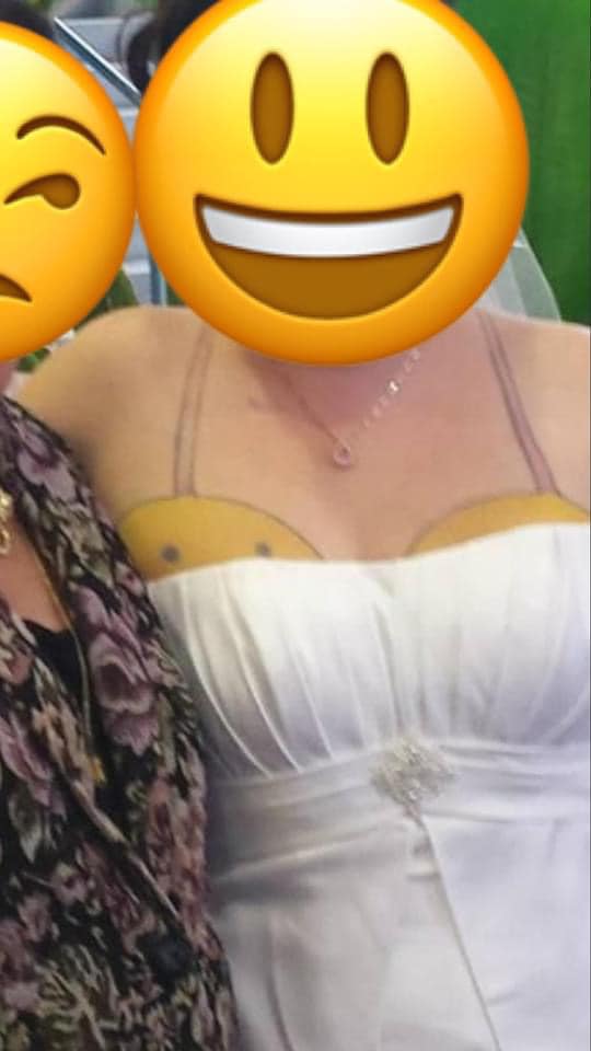 She appear to have two very large yellow emojis above each of her boobs