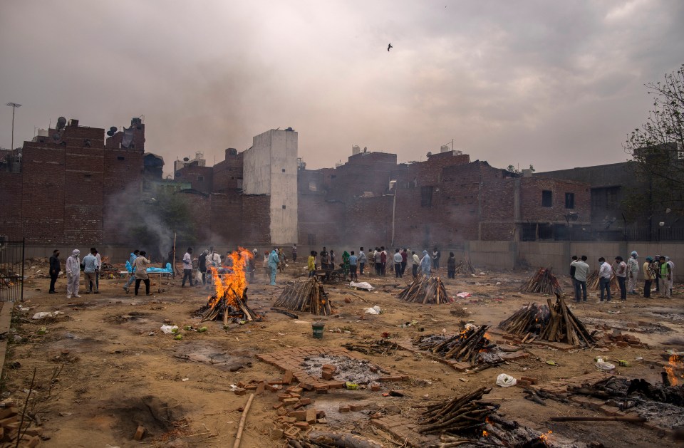 Multiple funeral pyres at a ground converted into a makeshift crematorium in New Delhi