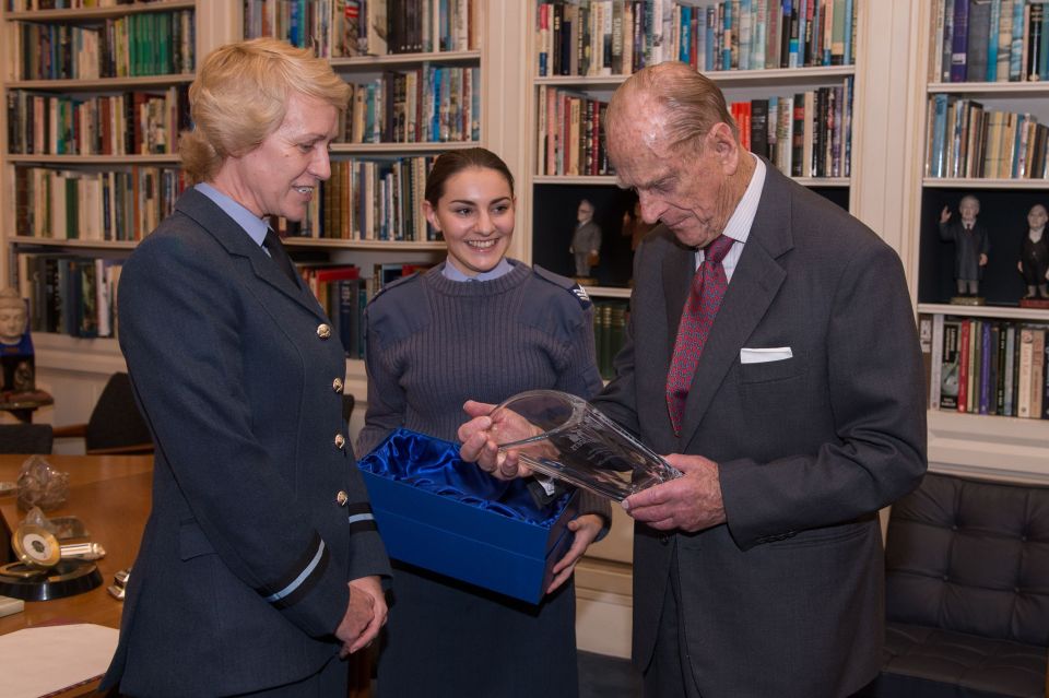 The Duke of Edinburgh as he is presented with a gift of a vase from Air Commodore Dawn McCafferty Commandant of the Air Cadet organisation