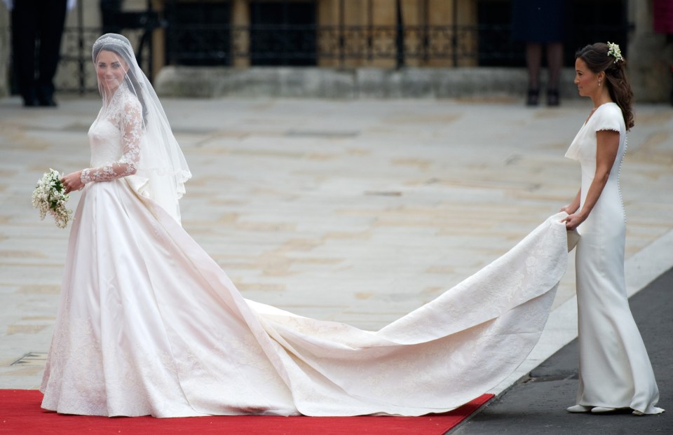 Aisle be there for you . . . Kate’s sister Pippa carries her 9ft-long train