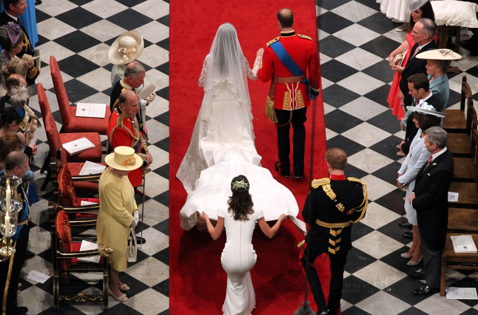 Royal train . . . newlyweds walk past their families as they leave the Abbey