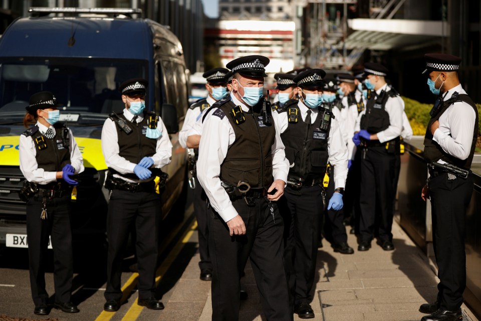 Officers swooped on the Canary Wharf office this morning