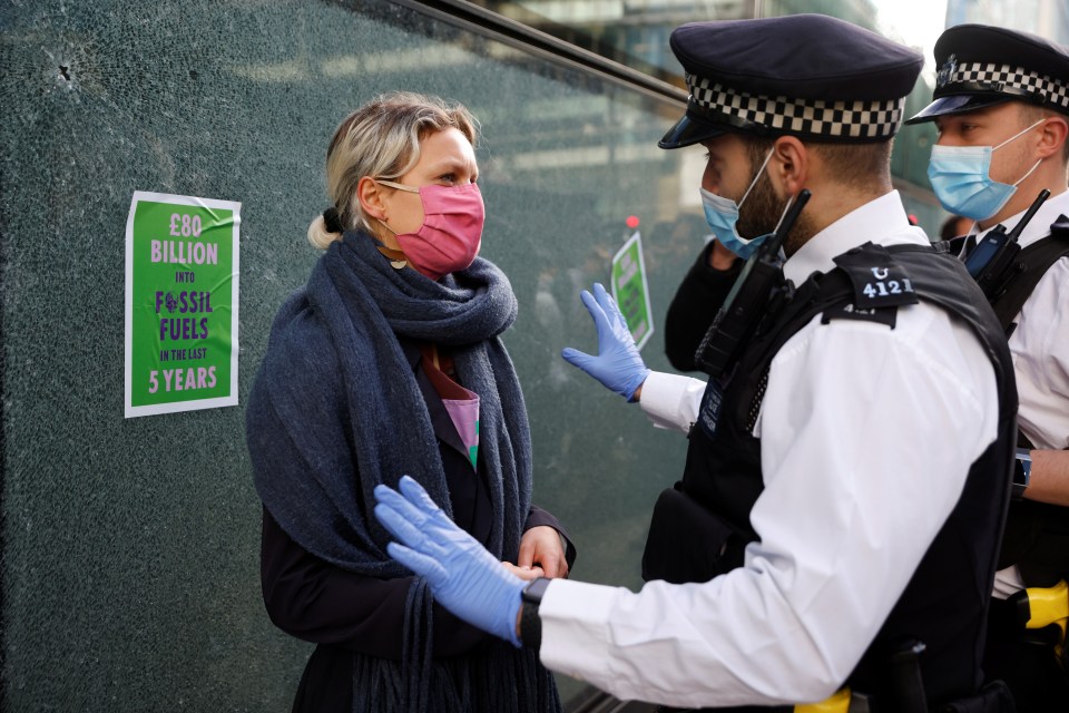 The masked women put up stickers on the glass after it was smashed