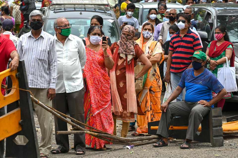 People queue to receive the Covid-19 vaccine at a centre in Mumbai