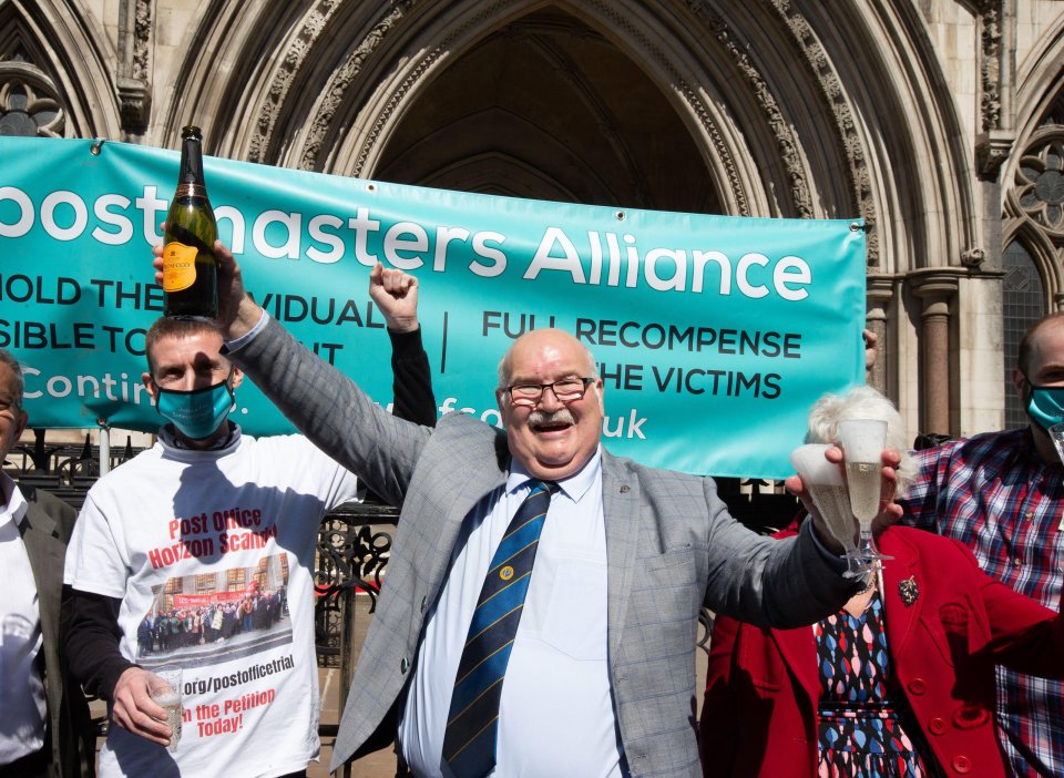 Former Post Office worker Tom Hedges (centre) pops a bottle champagne in celebration outside the Royal Courts of Justice