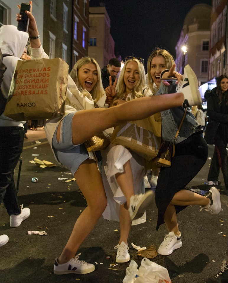 Friends make the most of restrictions easing in Soho, central London