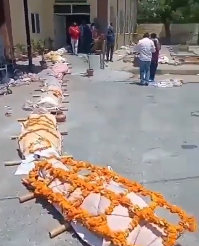 Hundreds of flower-decked victims were ceremonially burned because the nation’s overstretched crematoria were too busy to cope with the death toll