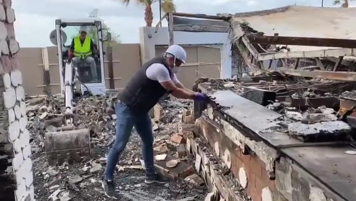 The star was seen getting stuck in with the demolition