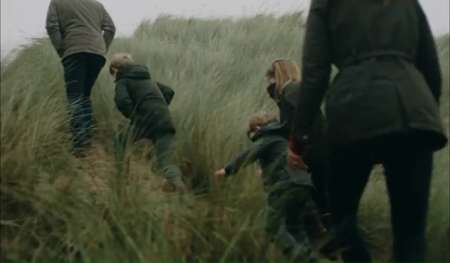 The family walked up sand dunes to get to a beach before cuddling up together