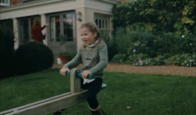 Charlotte spins round on a seesaw in the family garden in Norfolk