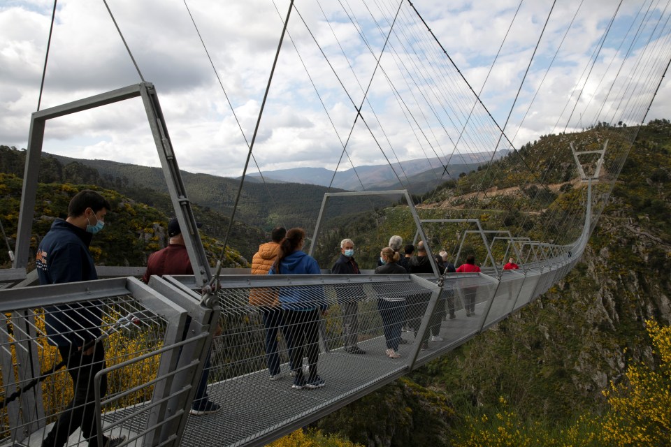 The bridge overlooks the river and cliffs with a sheer drop