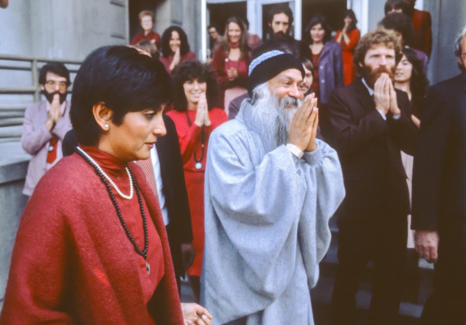 Ma Anand Sheela, left, with cult leader Bhagwan Shree Rajneesh, centre, in 1982