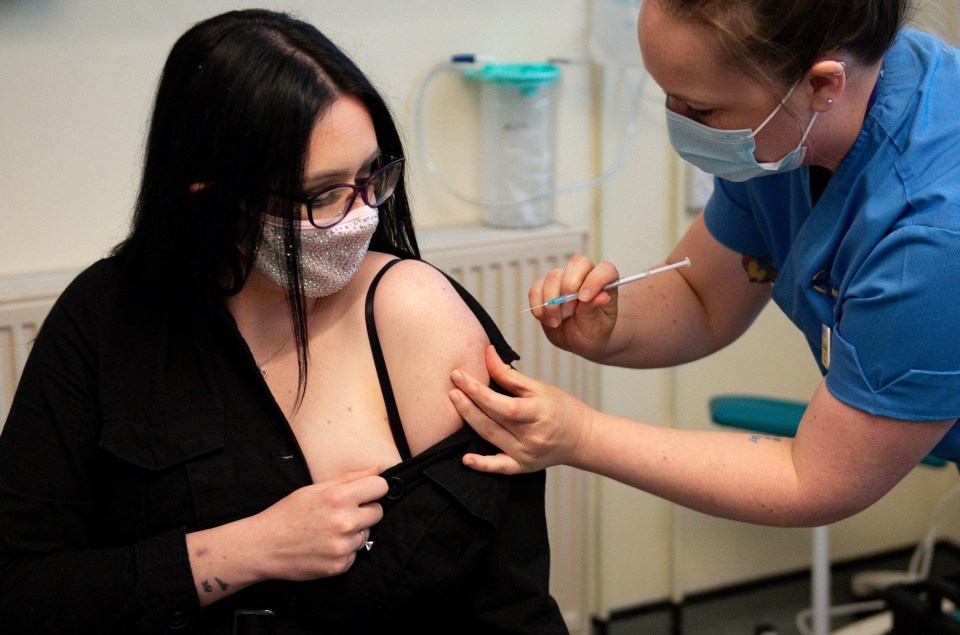 Unpaid carer Elle Taylor, 24, receives her first dose of the vaccine in Carmarthen