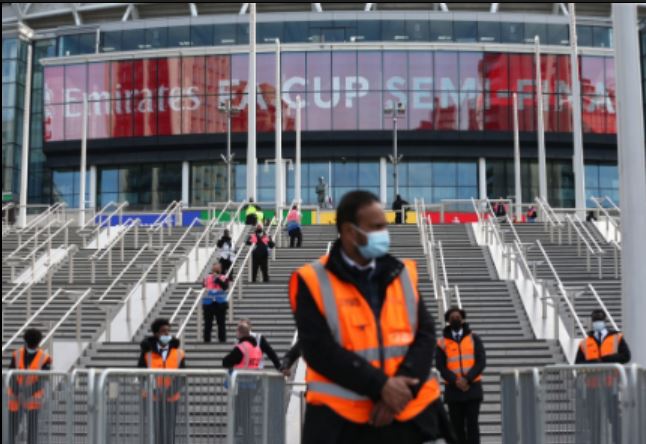 Stewards appeared to stick to social distancing as they waited to deal with fans