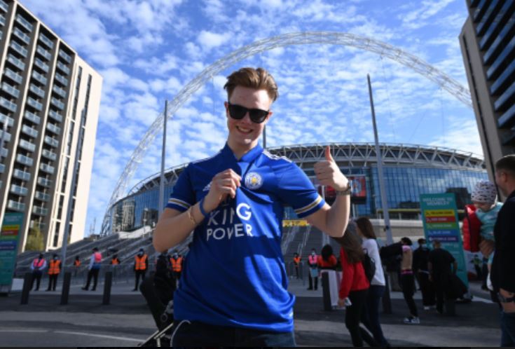 The smile says it all as this Leicester supporter knows he is in a privileged situation