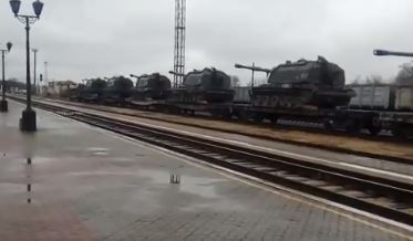 Howitzers are seen stacked on rail cars amid the tensions