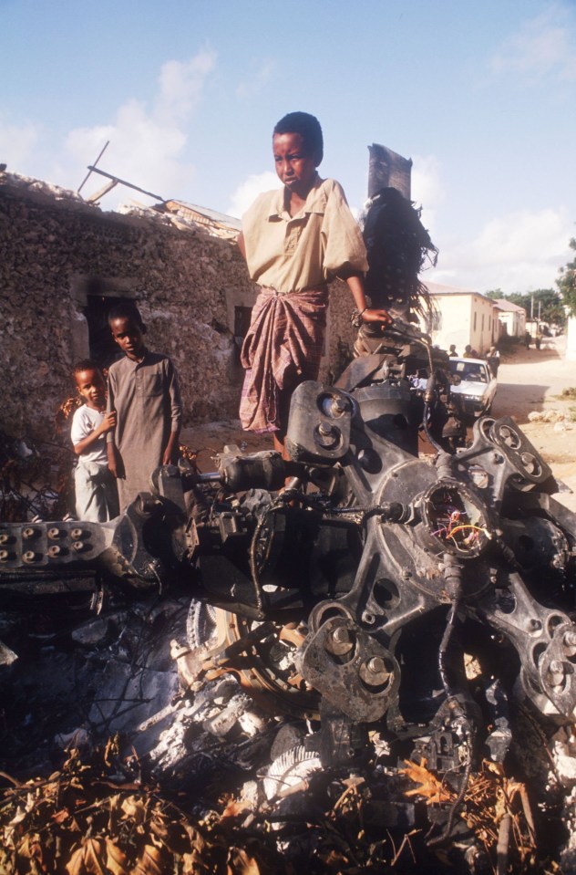 Children stand atop the wreckage of an American helicopter in 1993 in Mogadishu, Somalia