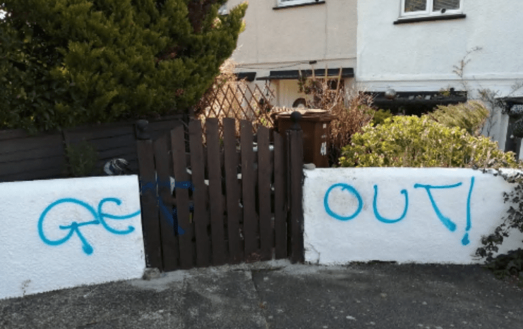 Graffiti was spray-painted on the wall of their home in Chatham, Kent